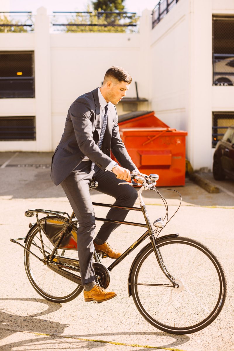 Man in suit riding bike. Nelson Mouellic Photo.